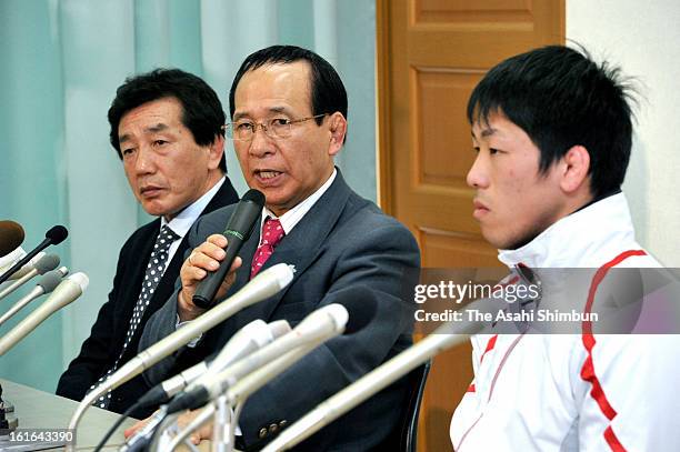 Japan Wrestling Federation President Tomiaki Fukuda speaks while gold medalist Tatsuhiro Yonemitsu listens during a press conference at Kishi...