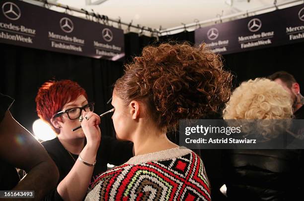 Model prepares backstage at the Zang Toi Fall 2013 fashion show during Mercedes-Benz Fashion Week at The Stage at Lincoln Center on February 13, 2013...