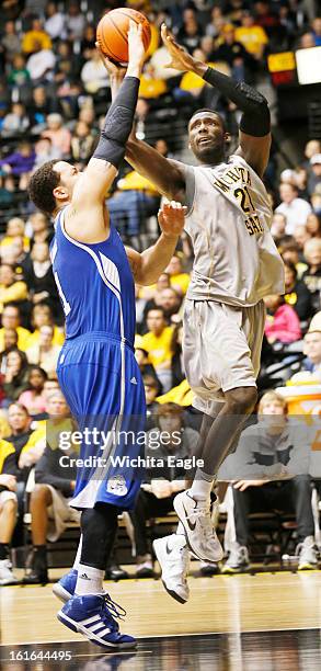 Wichita State's Ehimen Orukpe, right, is fouled while driving to the basket against Drake's Jordan Clarke in the second half at Koch Arena in...