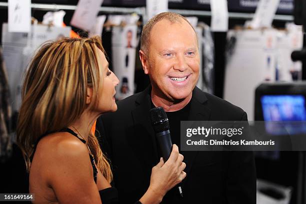 Designer Michael Kors prepares backstage at the Michael Kors Fall 2013 fashion show during Mercedes-Benz Fashion Week at The Theatre at Lincoln...