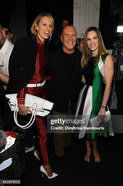 Karolina Kurkova, designer Michael Kors and actress Hilary Swank pose backstage at the Michael Kors Fall 2013 fashion show during Mercedes-Benz...