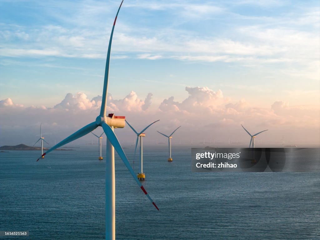 See wind turbines offshore from a high angle