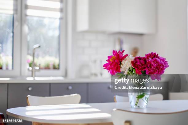 living room. kitchen. flowers in a white kitchen - kitchen bench stock pictures, royalty-free photos & images