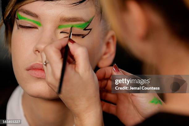 Model is prepped backstage at the Jeremy Scott fall 2013 fashion show during MADE Fashion Week at Milk Studios on February 13, 2013 in New York City.