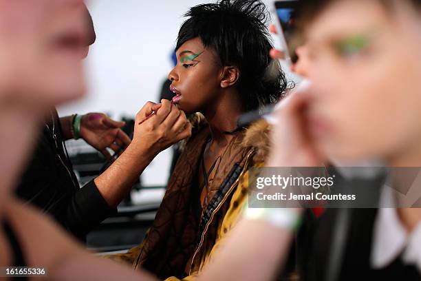 Model is prepped backstage at the Jeremy Scott fall 2013 fashion show during MADE Fashion Week at Milk Studios on February 13, 2013 in New York City.