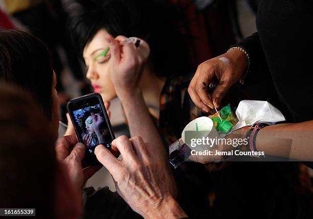 Make-up artist Kabuki preps model Lindsey Wixson ackstage at the Jeremy Scott fall 2013 fashion show during MADE Fashion Week at Milk Studios on...