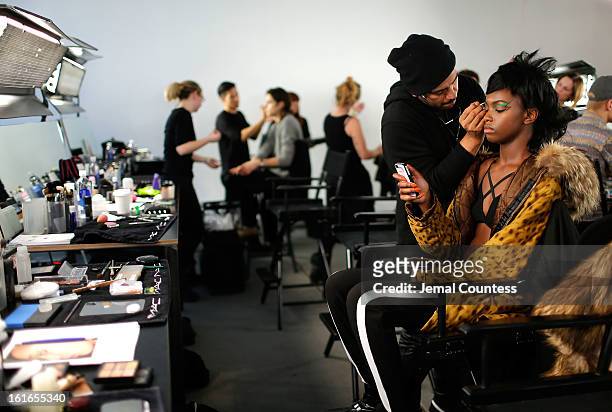 Model is prepped backstage at the Jeremy Scott fall 2013 fashion show during MADE Fashion Week at Milk Studios on February 13, 2013 in New York City.