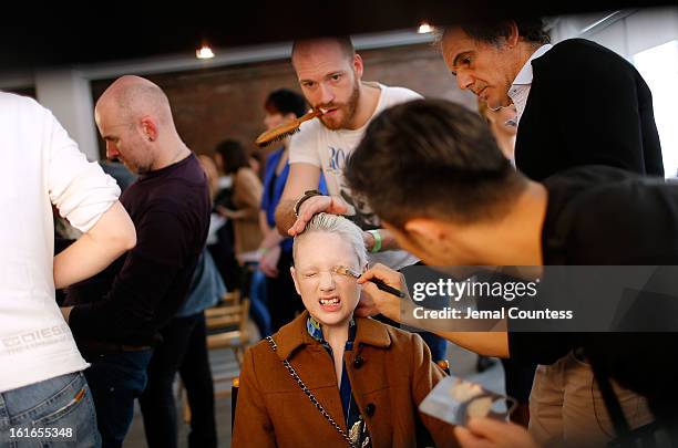 Model is prepped backstage at the Jeremy Scott fall 2013 fashion show during MADE Fashion Week at Milk Studios on February 13, 2013 in New York City.