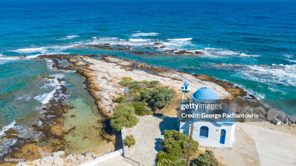 Blue and white church next to the sea