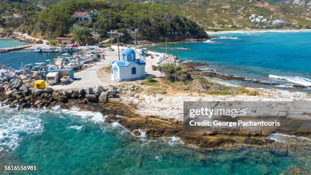 blue and white church next to the sea - ikaria island stock pictures, royalty-free photos & images