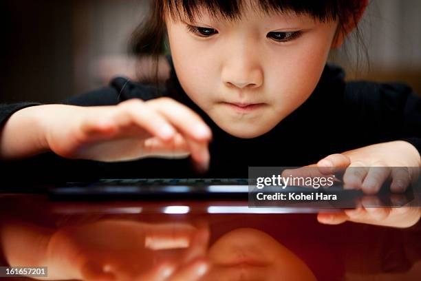 a girl using a digital tablet - child school technology stock pictures, royalty-free photos & images
