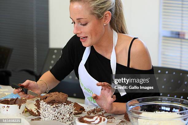 Reeva Steenkamp with the cake she baked on August 21, 2012 at the BBC Lifestyle launch of "Bake-off" in Sandton, South Africa. Celebrities and...