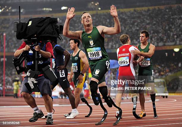 Oscar Pistorius of South Africa waves as he celebrates winning gold in the final of the 100m T44 during the 2008 Beijing Paralympic Games at the...