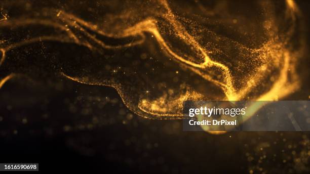 blurry glowing golden particles - particule photos et images de collection