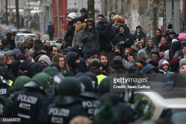 Protesters demonstrate near the entrance to Lausitzer Strasse 8 to prevent the eviction of the German-Turkish Gulbol family as riot police look on on...