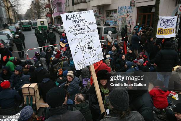 Protesters demonstrate near the entrance to Lausitzer Strasse 8 to prevent the eviction of the German-Turkish Gulbol family as riot police look on on...