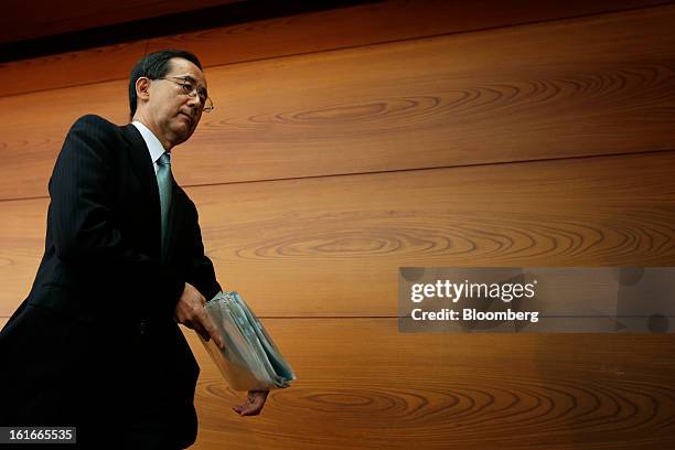 Masaaki Shirakawa, governor of the Bank of Japan, leaves a news conference at the central bank's headquarters in Tokyo, Japan, on Thursday, Feb. 14,...