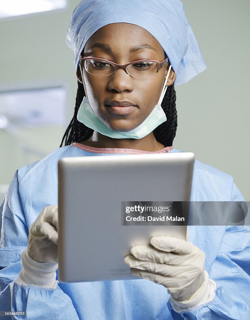 Female surgeon using a tablet computer