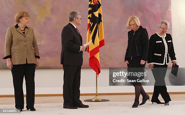 German President Joachim Gauck prepares to hand incoming German Education Minister Johanna Wanka her appointment papers as outgoing Education...