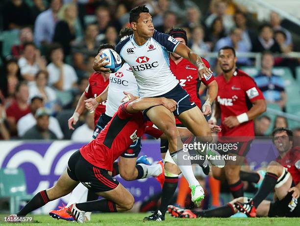 Israel Folau of the Waratahs takes on the defence during the Super Rugby trial match between the Waratahs and the Crusaders at Allianz Stadium on...