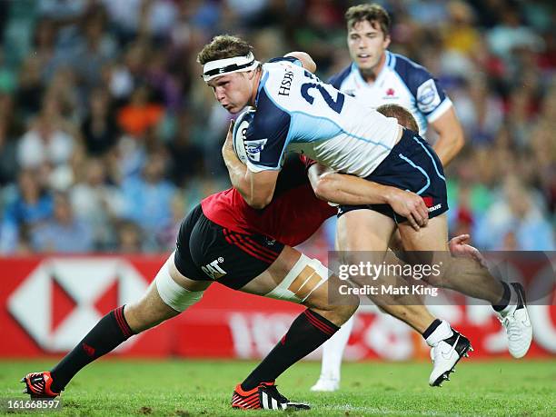 Michael Hooper of the Waratahs is tackled during the Super Rugby trial match between the Waratahs and the Crusaders at Allianz Stadium on February...