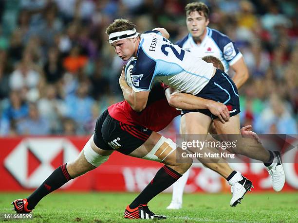 Michael Hooper of the Waratahs is tackled during the Super Rugby trial match between the Waratahs and the Crusaders at Allianz Stadium on February...