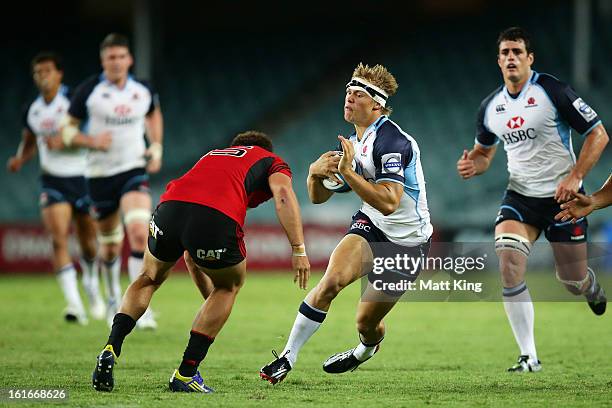 Tom Kingston of the Waratahs takes on the defence during the Super Rugby trial match between the Waratahs and the Crusaders at Allianz Stadium on...