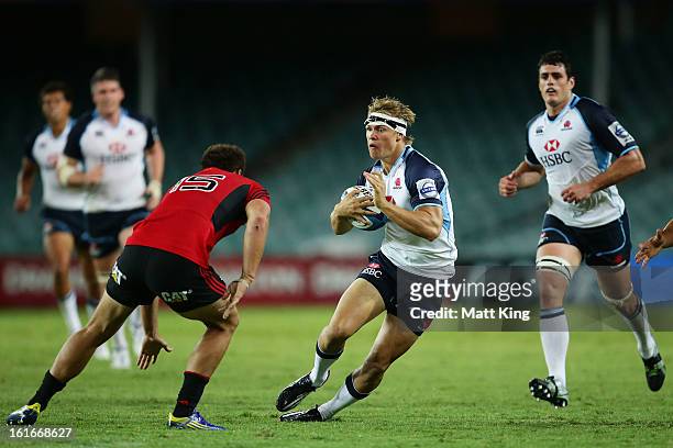 Tom Kingston of the Waratahs takes on the defence during the Super Rugby trial match between the Waratahs and the Crusaders at Allianz Stadium on...
