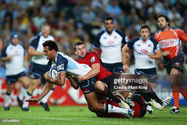 Ben Volavola of the Waratahs is tackled during the Super Rugby trial match between the Waratahs and the Crusaders at Allianz Stadium on February 14,...