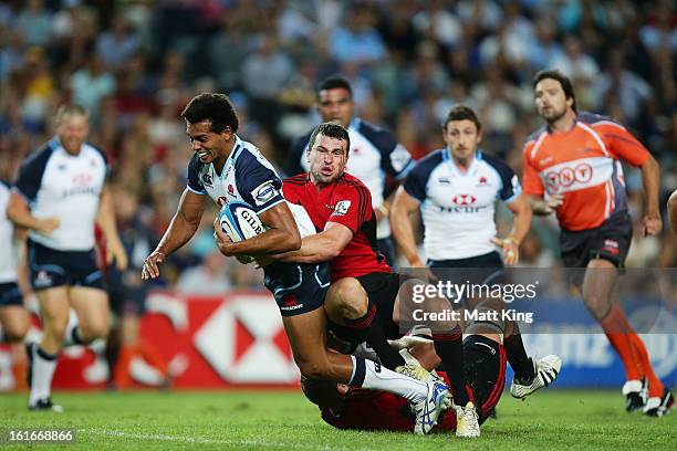 Ben Volavola of the Waratahs is tackled during the Super Rugby trial match between the Waratahs and the Crusaders at Allianz Stadium on February 14,...