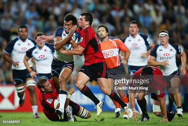 Ben Volavola of the Waratahs is tackled during the Super Rugby trial match between the Waratahs and the Crusaders at Allianz Stadium on February 14,...