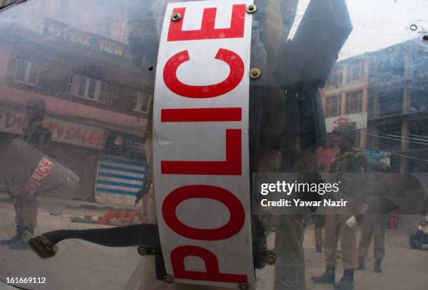 Indian policemen and paramilitary forces stand guard in the city centre during a relaxation in curfew, imposed after the execution of alleged Indian...