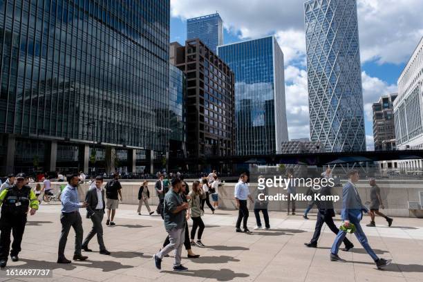 Lunchtime activity in Canary Wharf financial district as people walk past with the tower Newfoundland looming in the distance on 15th August 2023 in...
