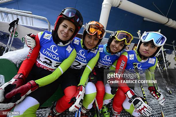 Iran's Fatemeh Kiadarbandsari, Ziba Kalhor, Marjan Kalhor and Mitra Kalhor pose after the Women's Giant slalom first run at the 2013 Ski World...