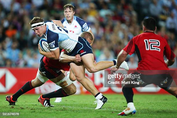 Michael Hooper of the Waratahs is tackled during the Super Rugby trial match between the Waratahs and the Crusaders at Allianz Stadium on February...