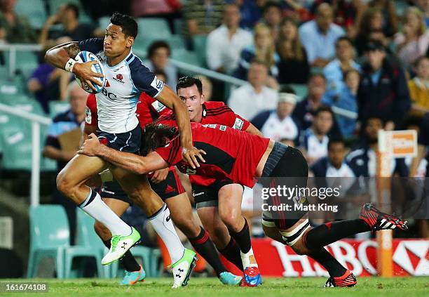 Israel Folau of the Waratahs makes a break during the Super Rugby trial match between the Waratahs and the Crusaders at Allianz Stadium on February...