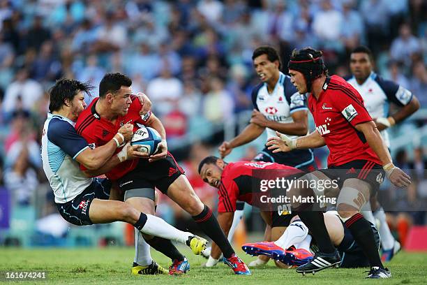 Ryan Crotty of the Crusaders is tackled by Adam Ashley-Cooper of the Waratahs during the Super Rugby trial match between the Waratahs and the...