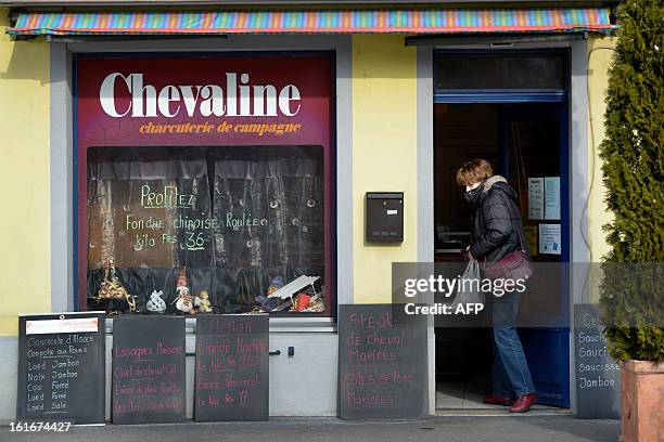 Woman leaves a horsemeat butchery on February 14, 2013 in Yverdon-Les-Bains. Swiss supermarket giant Coop said that it had found horsemeat in its...