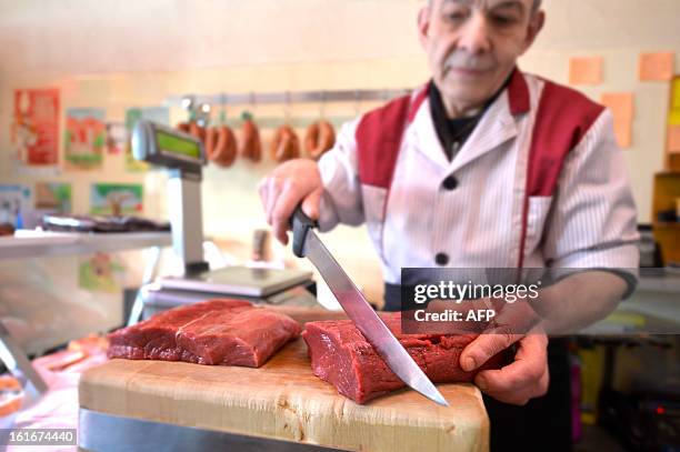 Butcher works in his horsemeat butchery on February 14, 2013 in Yverdon-Les-Bains. Swiss supermarket giant Coop said that it had found horsemeat in...