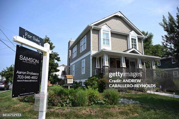 For sale sign in front of a home in Arlington, Virginia, on August 22, 2023. Sales of homes in the United States ticked down in July, according to...