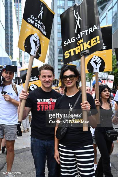 Ben McKenzie and Morena Baccarin walk a picket line in support of the SAG-AFTRA and WGA strike outside HBO/Amazon Corporate Headquarters in Hudson...