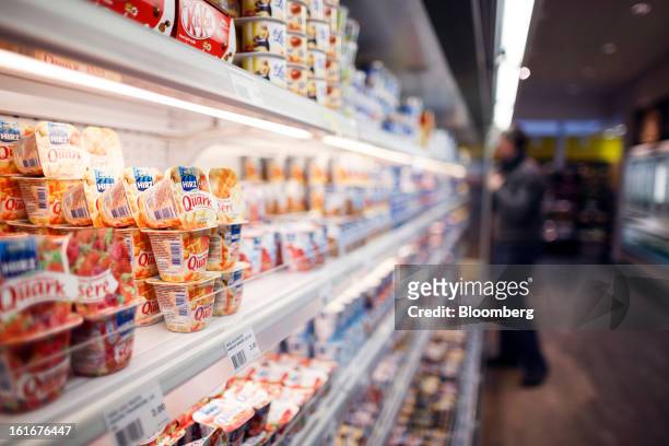 Cartons of Quark and other Nestle food products sit on display in a refrigerated cabinet inside a store at the Nestle SA headquarters in Vevey,...