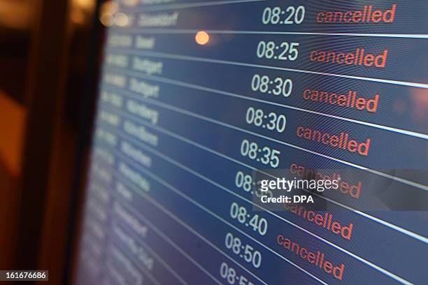 Departure board at the airport in Hamburg, northern Germany displays all flights as cancelled on February 14, 2013 due to a strike of security...