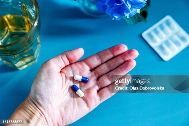 an overhead view of a hand with medicine in it - servant stock pictures, royalty-free photos & images