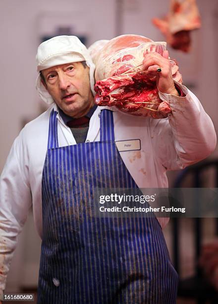 Worker carries a cut of meat at Liverpool Wholesale Meat Market on February 14, 2013 in Liverpool, England. British high street butchers are enjoying...