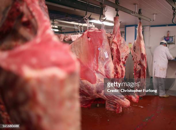 Cuts of beef hang inside a meat wholesalers at Liverpool Wholesale Meat Market on February 14, 2013 in Liverpool, England. British high street...