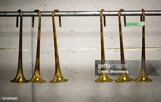 Trumpet bells hang before being be buffed and polished in the manufacturing department of the E.K Blessing Co. In Elkhart, Indiana, U.S., on...