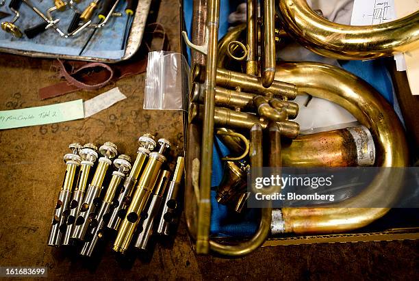 Parts for a brass wind instrument sit on a table before assembly in the manufacturing department of the E.K Blessing Co. In Elkhart, Indiana, U.S.,...