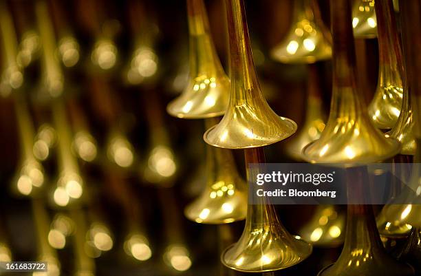 Stacked trumpet bells wait to be buffed and polished in the manufacturing department of the E.K Blessing Co. In Elkhart, Indiana, U.S., on Thursday,...