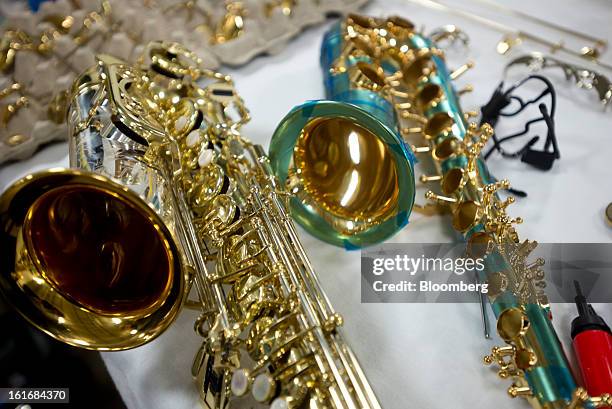 Saxophones sit on a work bench in the manufacturing department of the E.K Blessing Co. In Elkhart, Indiana, U.S., on Thursday, Feb. 7, 2013....